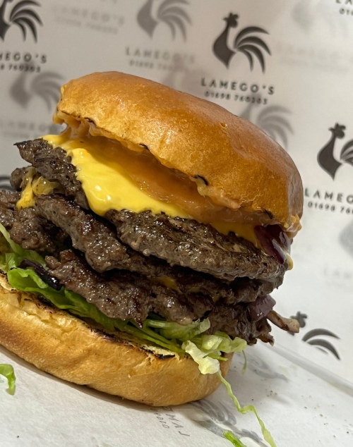 Lamego’s triple smash burger with melted cheese, lettuce and sauce on a brioche bun.