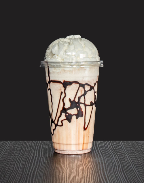      Lamego’s Creamy milkshake with whipped cream and chocolate drizzle in a clear cup. 