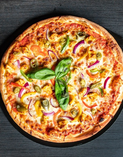Lamego’s Fresh pizza topped with cheese, onions, olives, peppers, and basil leaves. 